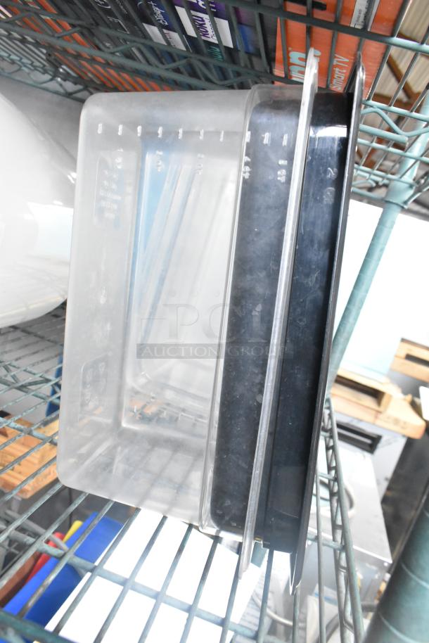 Three-tier lot on shelving, featuring clear poly drop-in bin lids and black cylindrical bins, good condition.