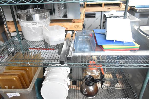 Three-tier metal shelf with coffee pots, poly drop-in bin lids, transparent bins, and colorful cutting boards. Mixed condition.
