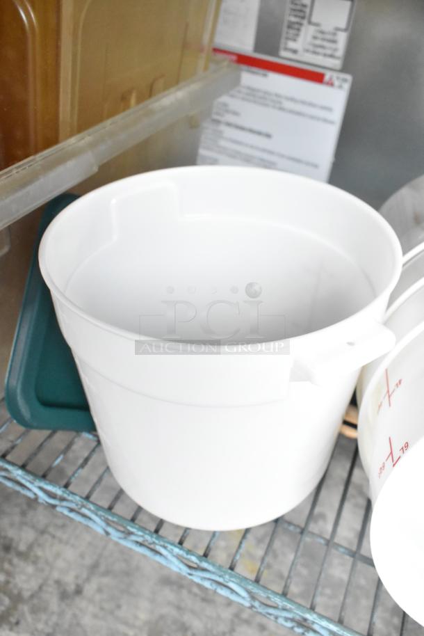 Three-tier lot including white poly cylindrical bins on a metal shelf. Visible lids and labels; ideal for storage.