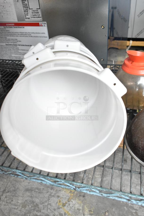 Three-tier lot with stacked poly drop-in bin lids, a coffee pot with red lid, and visible labeling in background.