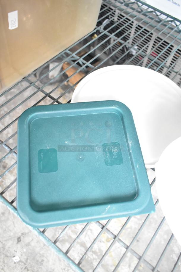 Three-tier lot with poly drop-in bin lids and cylindrical bins on shelf; tag marked "202" visible. Various conditions.