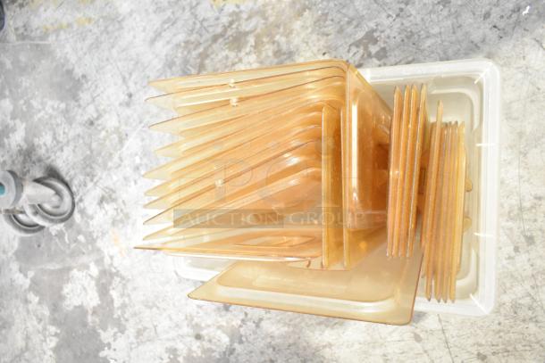 Three tier lot of poly drop-in bin lids, stacked in a square, light brown color, on a textured surface.
