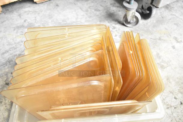 Three-tier lot featuring poly drop-in bin lids in used condition, stacked in a transparent bin.