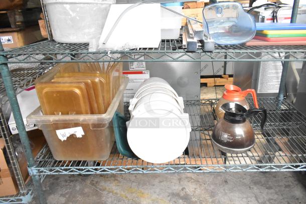 Three-tier metal shelving unit with coffee pots, poly drop-in bin lids, and cylindrical bins. Used condition.