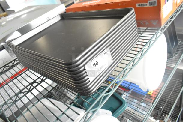 12 metal half-size baking pans stacked on a wire shelf, marked "66." Ideal for auction, excellent condition.
