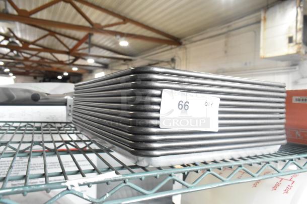 12 stackable metal half-size baking pans, excellent condition, auction label "66 QTY," displayed on a wire shelf.