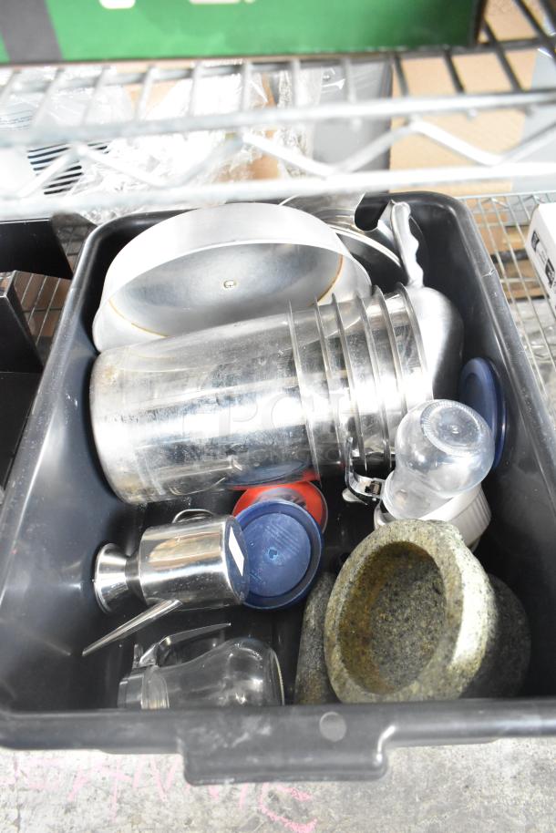 Auction lot of 19 items including metal bins, bus bin, and black poly 3-tier rack, featuring assorted kitchenware and containers.