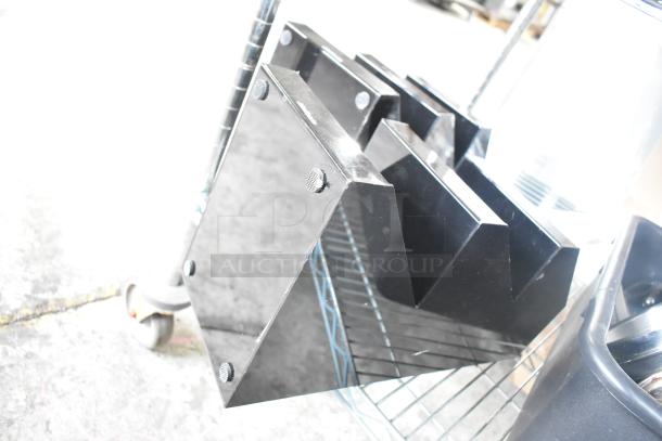 Black poly 3-tier rack on a metal shelf. Includes multiple black bins and a gray bus bin. Items in good condition.