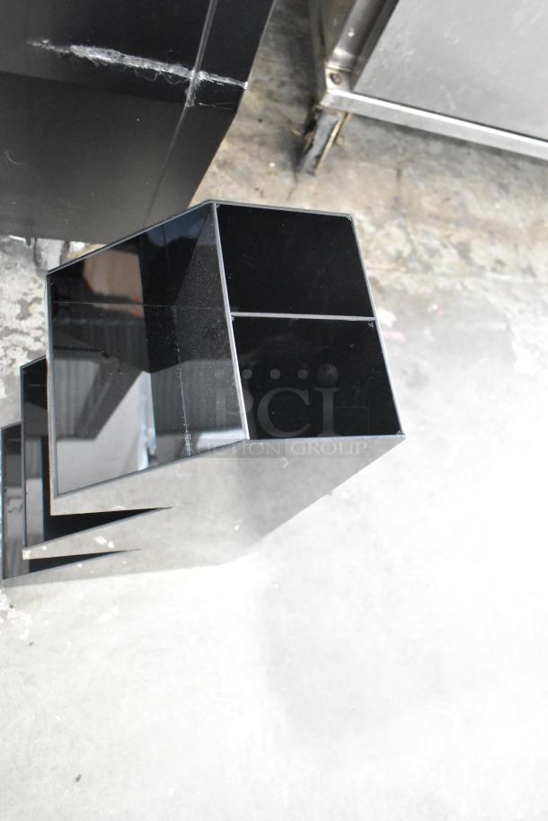 Black poly 3-tier rack in good condition on a concrete floor, part of a 19-item auction including metal bins and a bus bin.