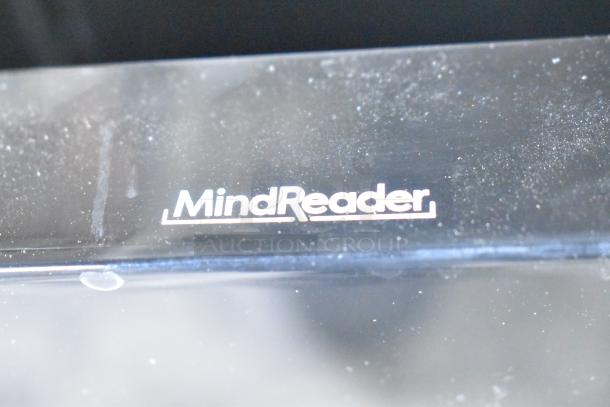 Close-up of a "MindReader" branded surface, likely part of the black poly 3-tier rack. Visible signs of dust.