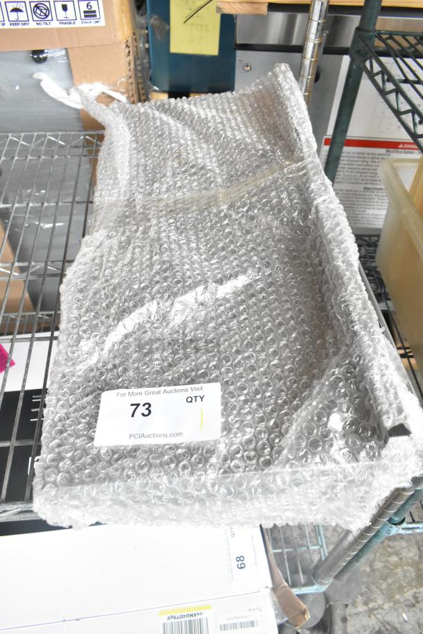 Metal shelf wrapped in bubble wrap on a storage rack. Label shows "73 QTY" for PCI Auctions. Appears new and unused.