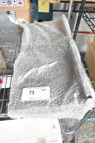 Metal shelf wrapped in bubble wrap on a storage rack. Label shows "73 QTY" for PCI Auctions. Appears new and unused.