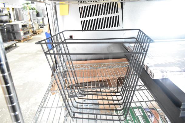 Metal wire basket on a shelf, part of a set of 9 items including cutting board rack and pictures, auctioned as a lot.