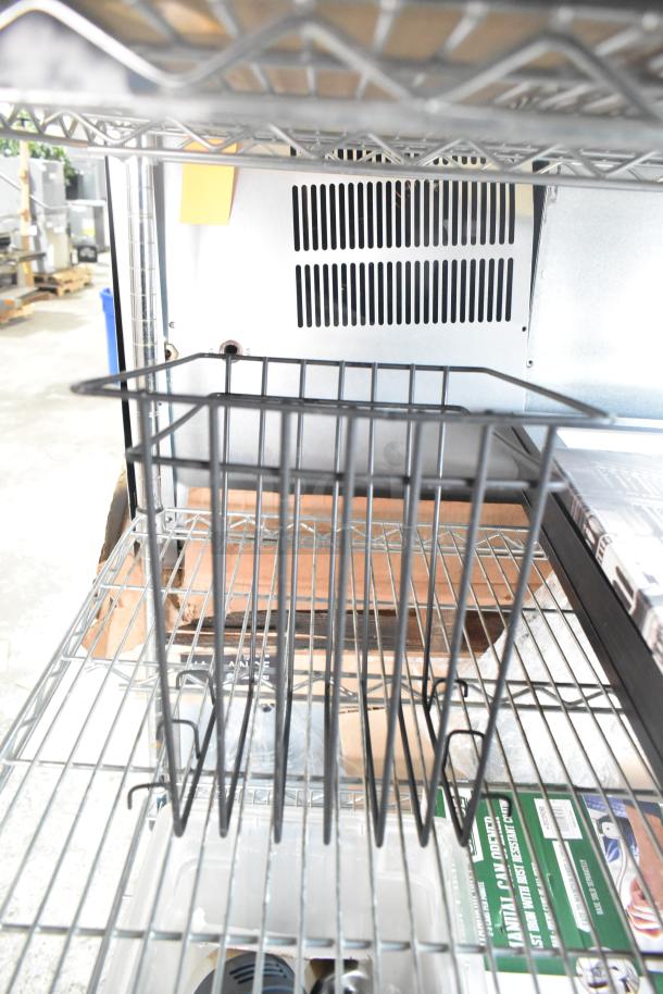 Metal cutting board rack on a wire shelf, part of a lot of nine items. Used condition, suitable for organizing boards.