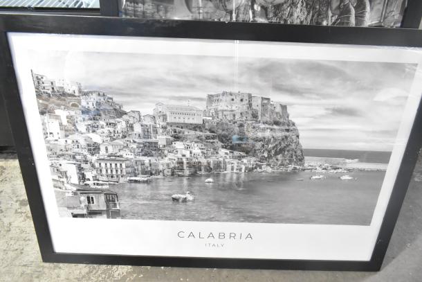 Framed black and white photograph labeled "Calabria, Italy," depicting a coastal village view.
