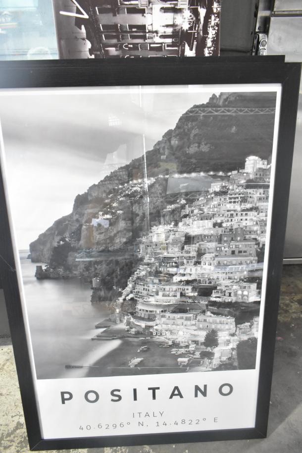 Framed black and white Positano print, labeled "Positano Italy" with coordinates, features coastal view.