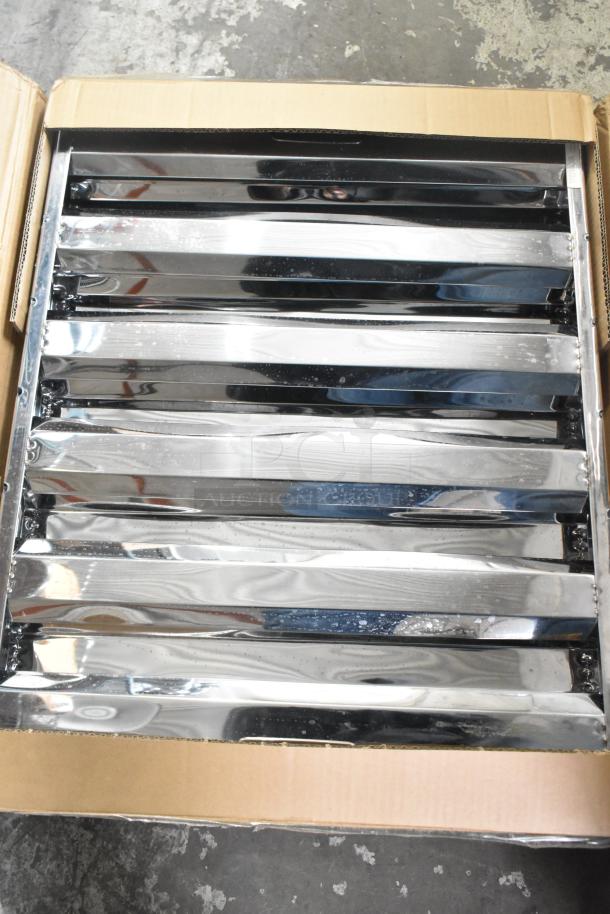 Box containing two brand new grease hood filters with visible surface scratches and dents.