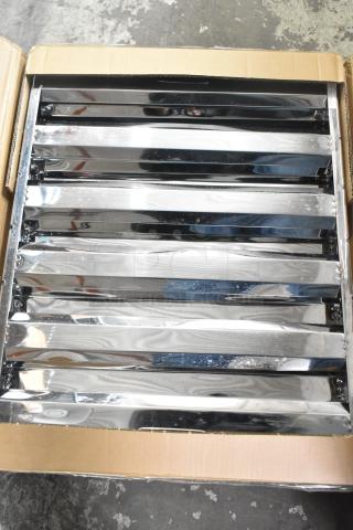 Box containing two brand new grease hood filters with visible surface scratches and dents.