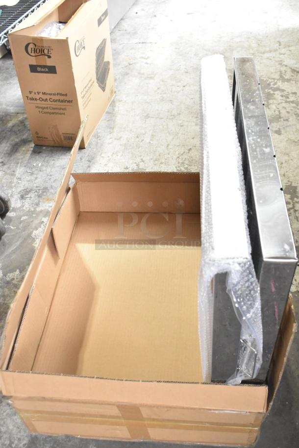 Box containing two brand new scratch and dent grease hood filters, partially packaged in bubble wrap. Box shows minor wear.