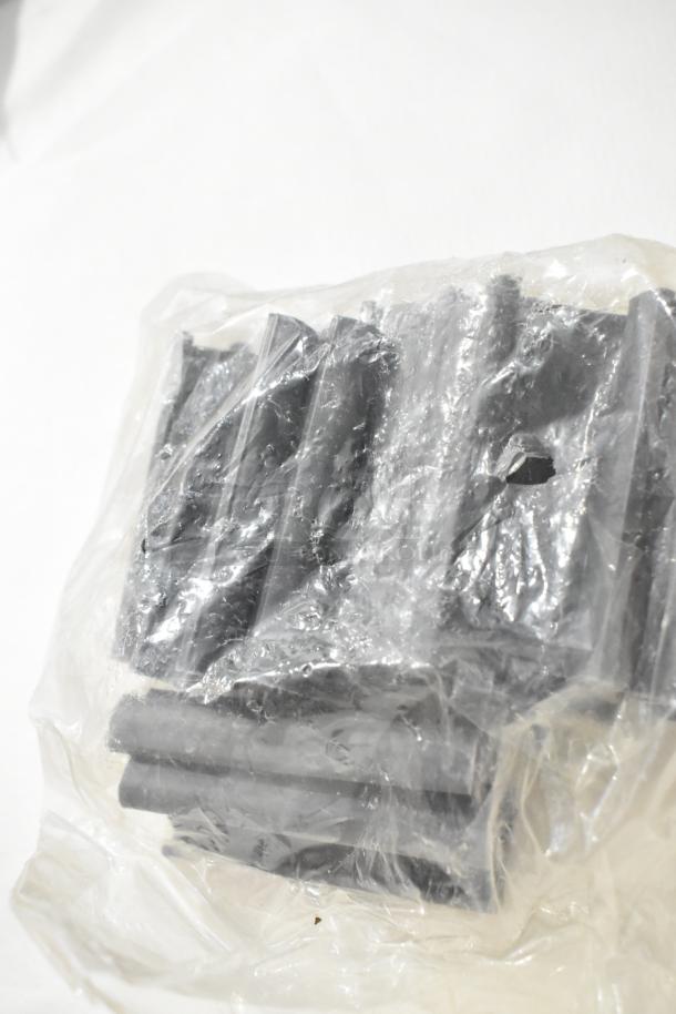 Clear plastic bag contains assorted black plastic components. Items are sealed and appear unused.