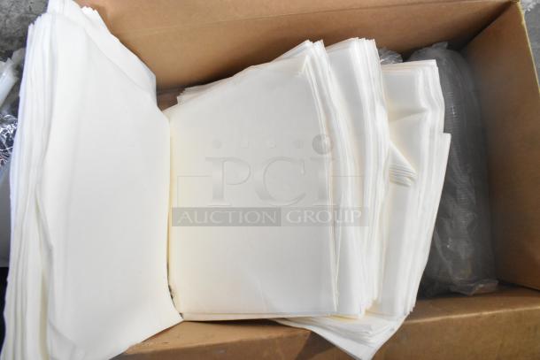 Box containing various items, including stacks of white paper and plastic-wrapped components. Condition appears used.