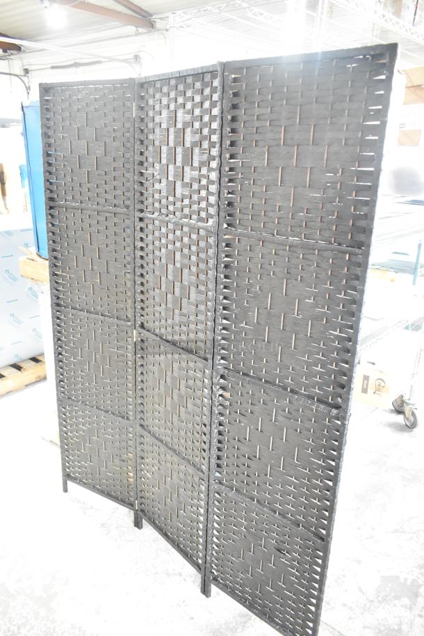 Trifold wicker-style room divider with a woven pattern, in good condition. Freestanding, versatile for interior use.