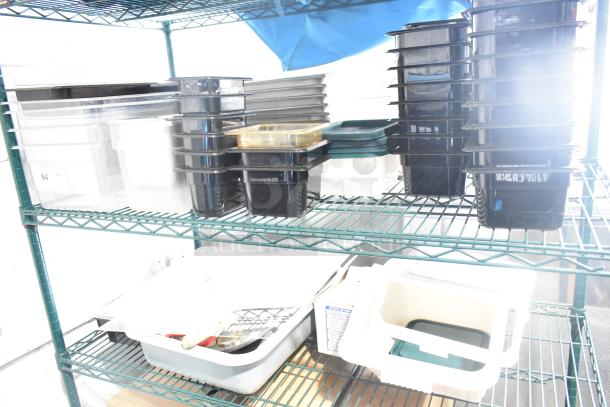 Two-tier shelf with poly drop-in bins, utensils, and ingredient bin. Various sizes, mostly black and clear. Good condition.