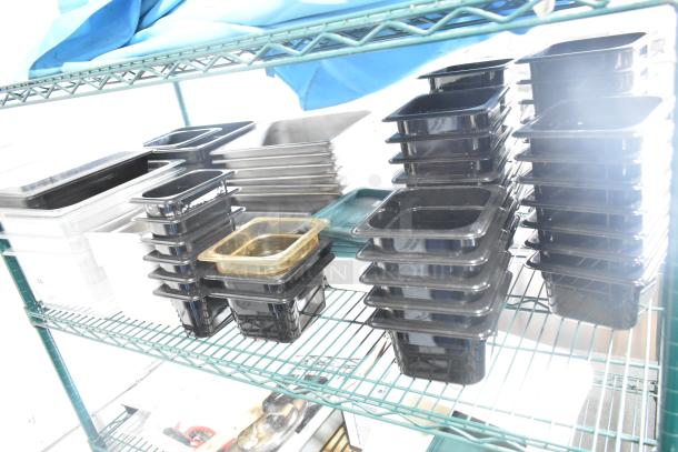 Two-tier shelving with poly drop-in bins, utensils, and ingredient bin, in good condition, for auction sale.