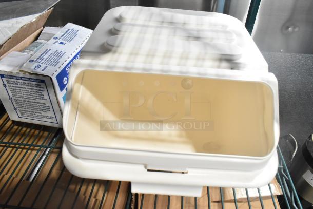 Two-tier lot with poly drop-in bin, utensils, and ingredient bin on metal shelf; sanitizer box visible.