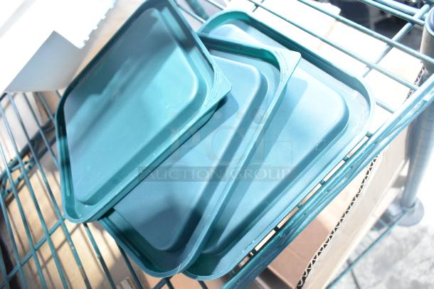 Alt text: Auction lot with poly drop-in bins, utensils, and ingredient bin on metal rack. Includes teal bin lids.