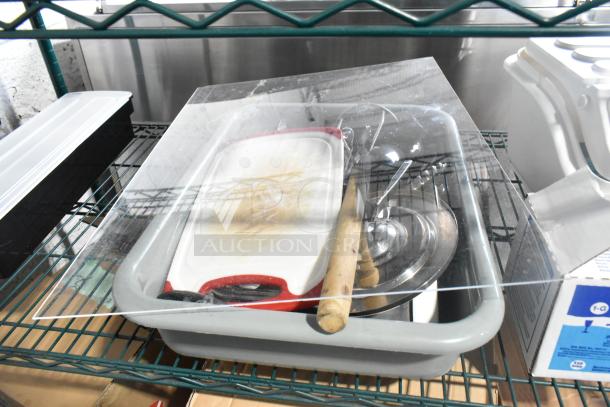 Two-tier lot with poly drop-in bins, utensils, ingredient bin, lids, cutting board, and various kitchen tools on metal shelves.