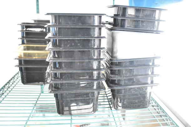 Two-tier lot with poly drop-in bins and utensils on a metal rack. Various sizes and conditions, suitable for kitchen use.