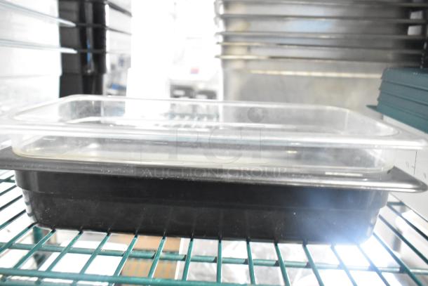 Two-tier lot including poly drop-in bins, utensils, and ingredient bin on metal racks. Items appear in used condition.