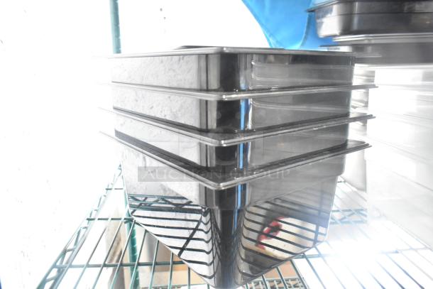 Two-tier lot with poly drop-in bins, utensils, and ingredient bin. Items stacked on a metal shelf, good condition.