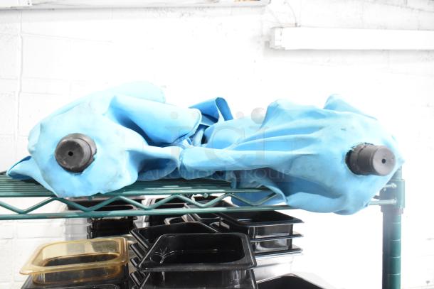 Two blue patio umbrellas, closed, with poles visible, in used condition on a metal shelf.