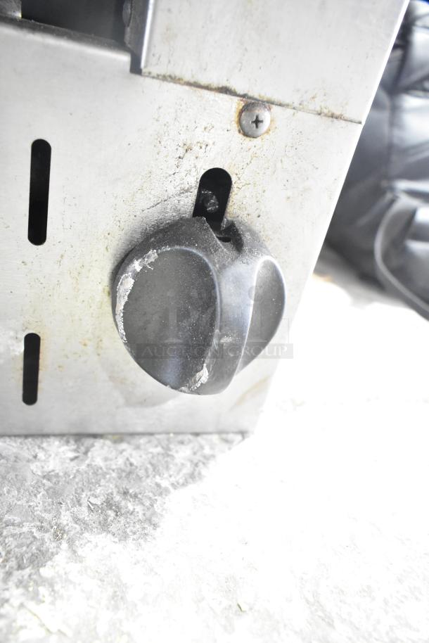 Vulcan Commercial Gas Cheese Melter knob with wear marks, stainless steel surface, and adjustable temperature control.