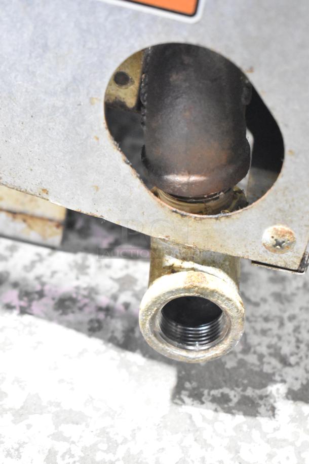 Vulcan Commercial Gas Cheese Melter showing a close-up of a gas connection, metal casing, and signs of wear.