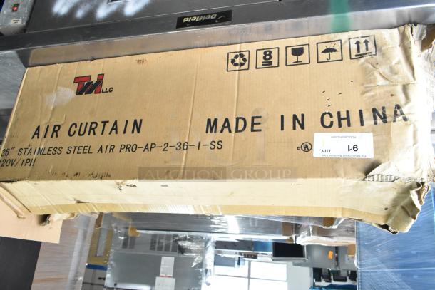 Brand new Curton PRO-AP-2-36-1-SS air curtain, 120V, 1 phase. Box labeled "Made in China," showing minor scratches and dents.