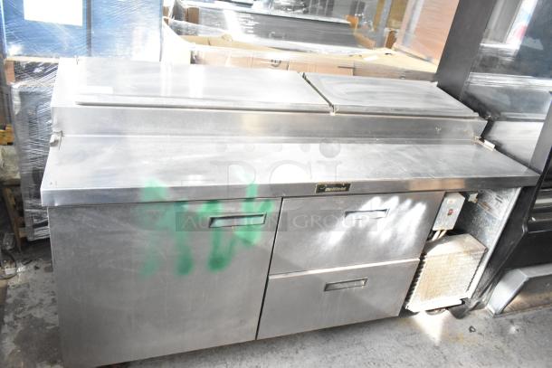 Delfield 18672PTBM-C commercial pizza prep table with 2 drawers, 1 door, in used condition. Stainless steel exterior. Model label visible.