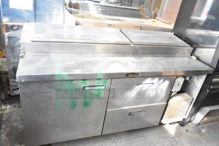Delfield 18672PTBM-C commercial pizza prep table with 2 drawers, 1 door, in used condition. Stainless steel exterior. Model label visible.