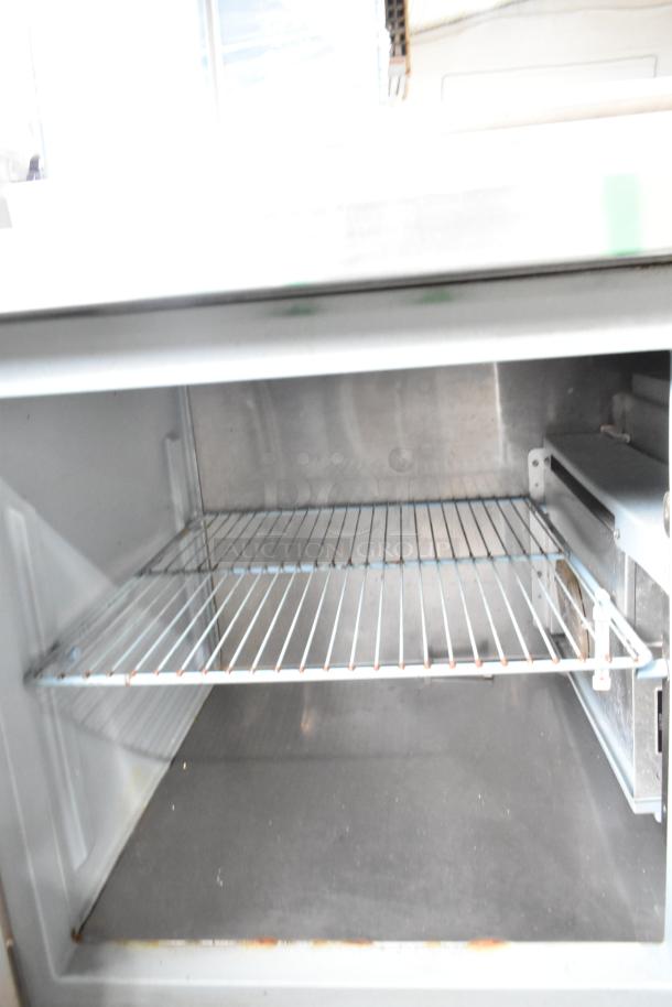 Delfield 18672PTBM-C pizza prep table with 2 drawers, 1 door, and stainless interior. Visible wire shelf, 115V, 1 phase.