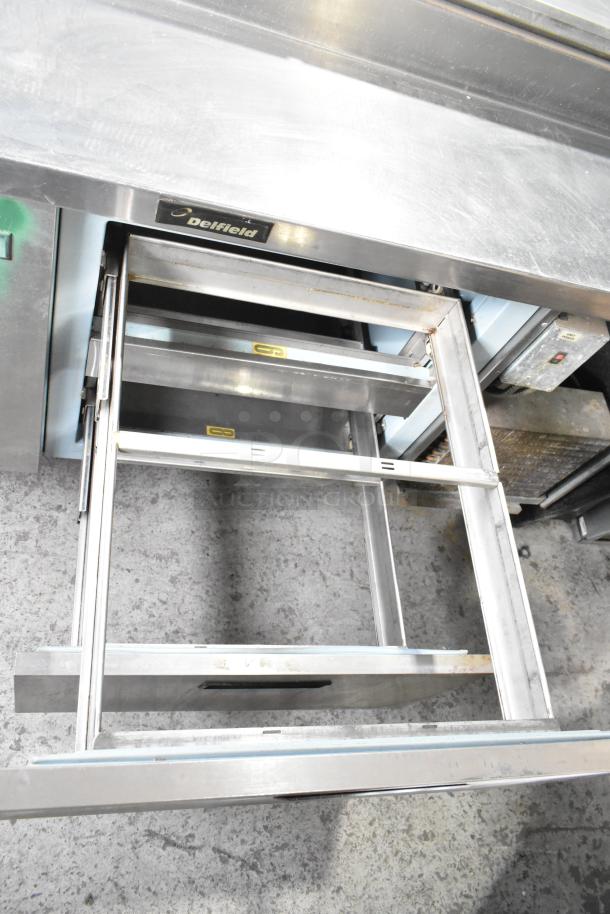 Delfield 18672PTBM-C pizza prep table with 2 drawers, 1 door. Stainless steel, 115 volts, 1 phase, visible Delfield label.
