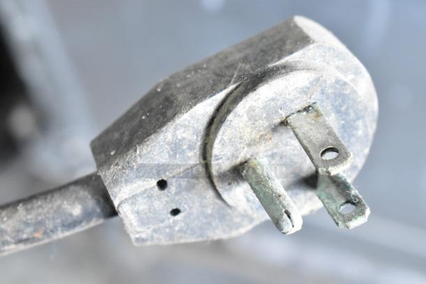 Close-up of a weathered plug on a Delfield 18672PTBM-C Commercial Pizza Prep Table. 115 volts, 1 phase.