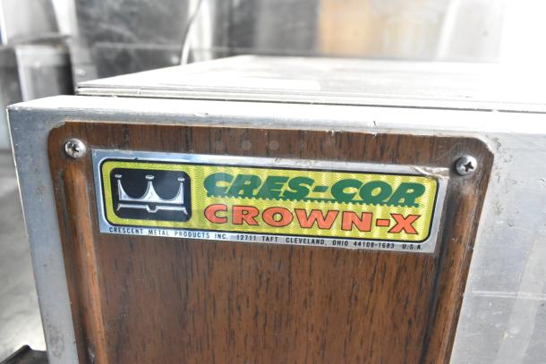 Cres-Cor Crown-X Commercial Holding Cabinet label, visible on a wood panel, indicates model and make.