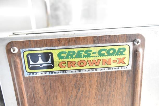 Cres-Cor Crown-X commercial holding cabinet on casters, featuring a woodgrain panel and Cres-Cor logo tag for identification.