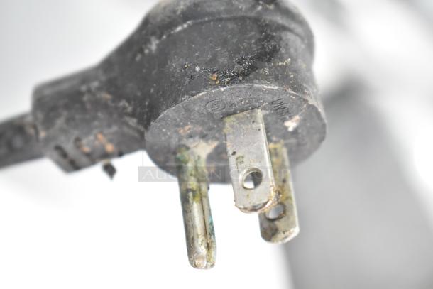 Close-up of a worn electrical plug for the 2019 True TRCB-48 Commercial Chef Base, showing signs of use.