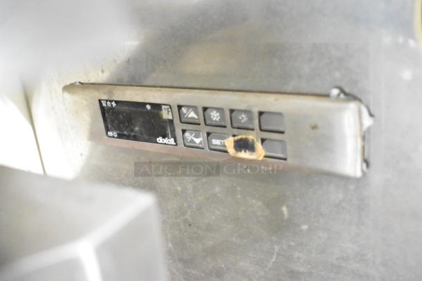 Control panel of Strike C83F-G12-STL Gelato Case Merchandiser, showing buttons and temperature display.