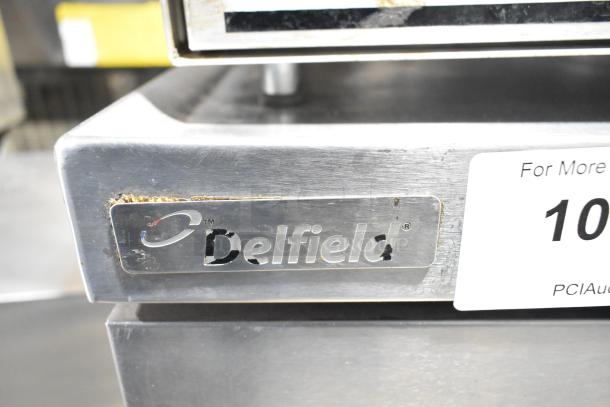Delfield 2 Drawer Chef Base, commercial casters, 115V, 1 phase, some surface wear, Delfield logo visible.