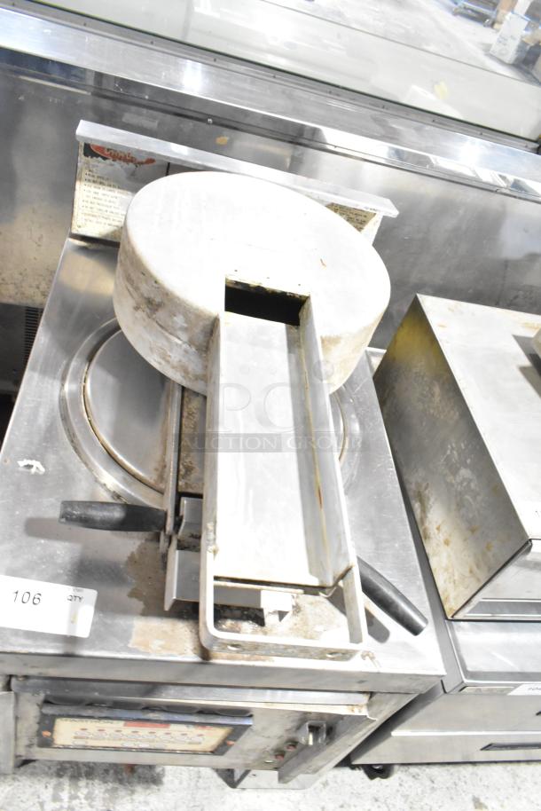 Commercial floor-style pressure fryer with stainless steel body. Visible wear and signs of use; control panel intact.