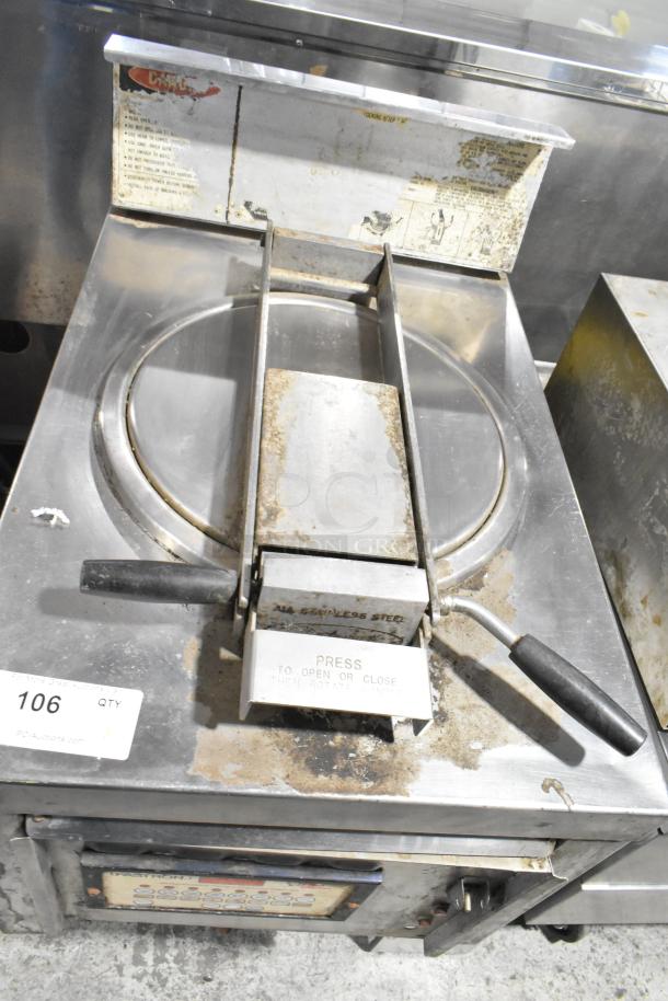 Commercial floor-style pressure fryer, stainless steel, visible wear, instructional labels, front control panel, unit number 106.